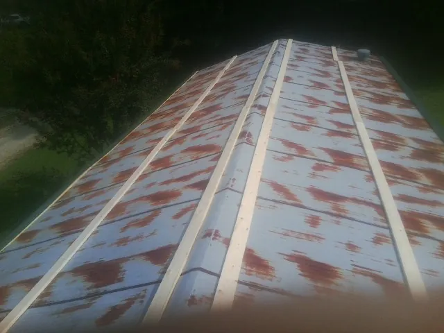 Rusted metal roof panels with new wood purlins before replacement — Storm Damage Roof Repair in Benicia by Roofing Brothers